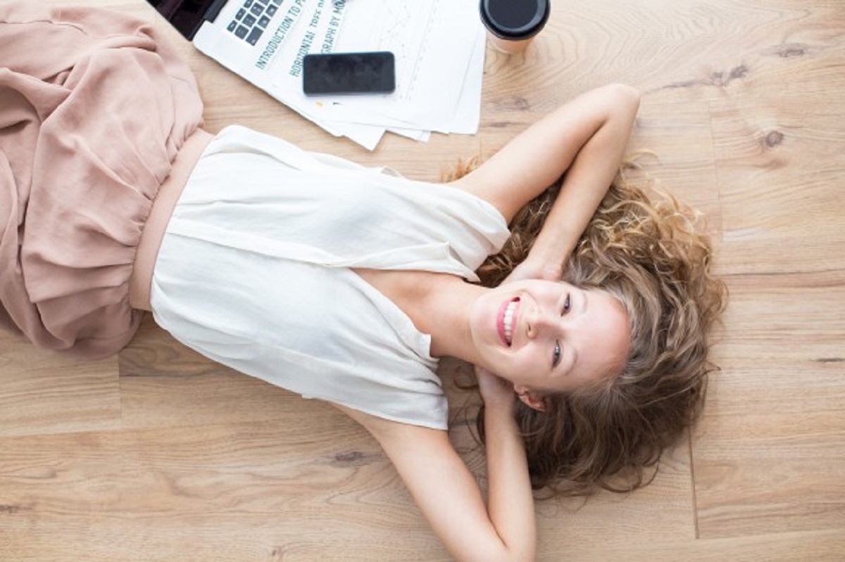 happy-beautiful-girl-lying-floor-relaxing_1262-5088