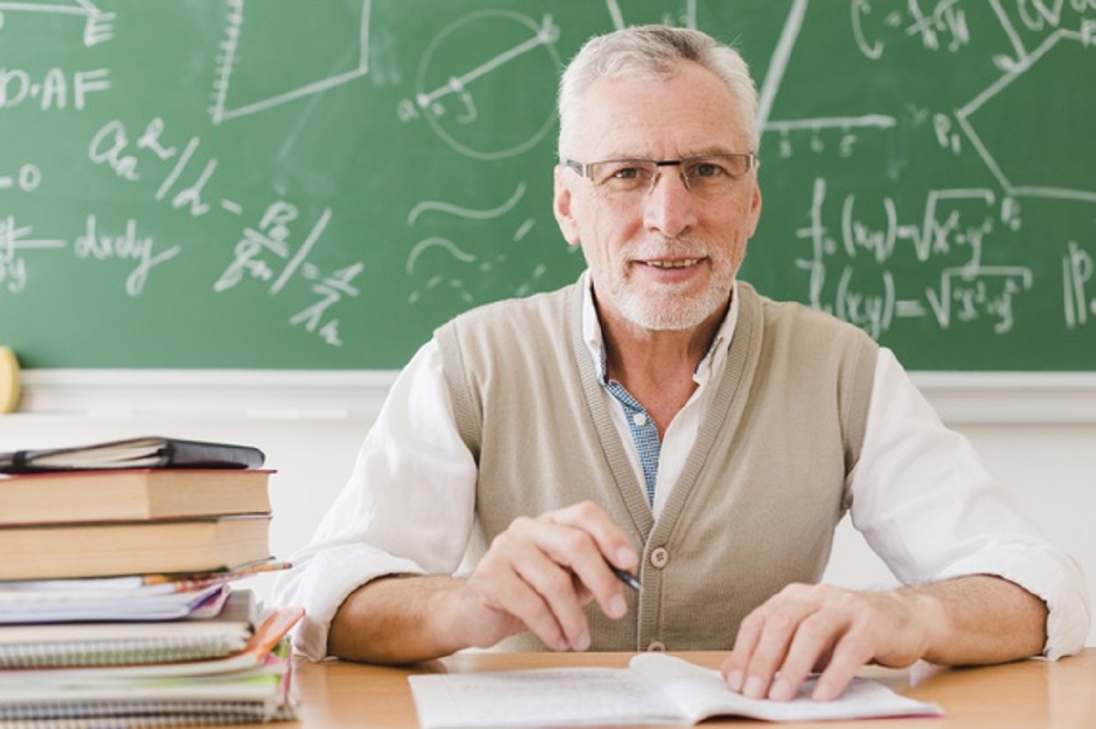 senior-professor-sitting-desk-lecture-room_23-2148201070