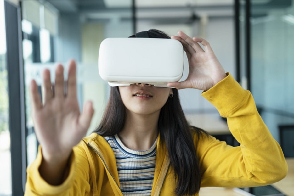 Young programmer with virtual reality glasses to testing 3D appl