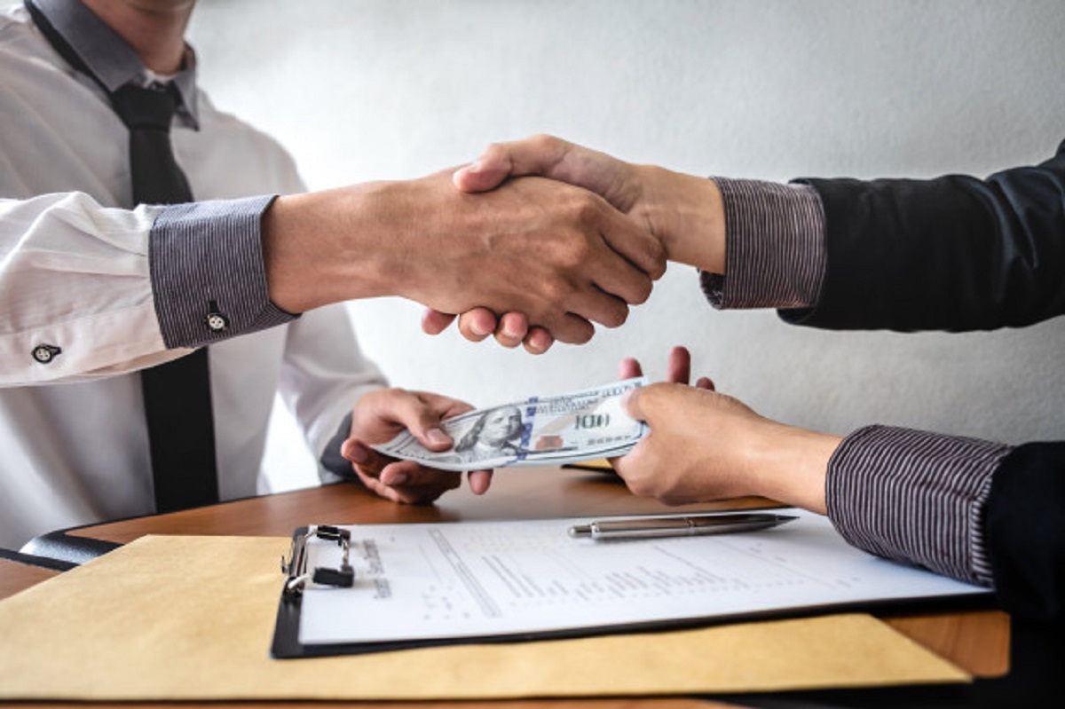 businessman-handshake-with-money-dollar-banknotes-hands-from-while-give-success-contract_122498-59