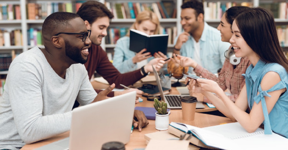 group-ethnic-multicultural-students-sitting-table_99043-4322
