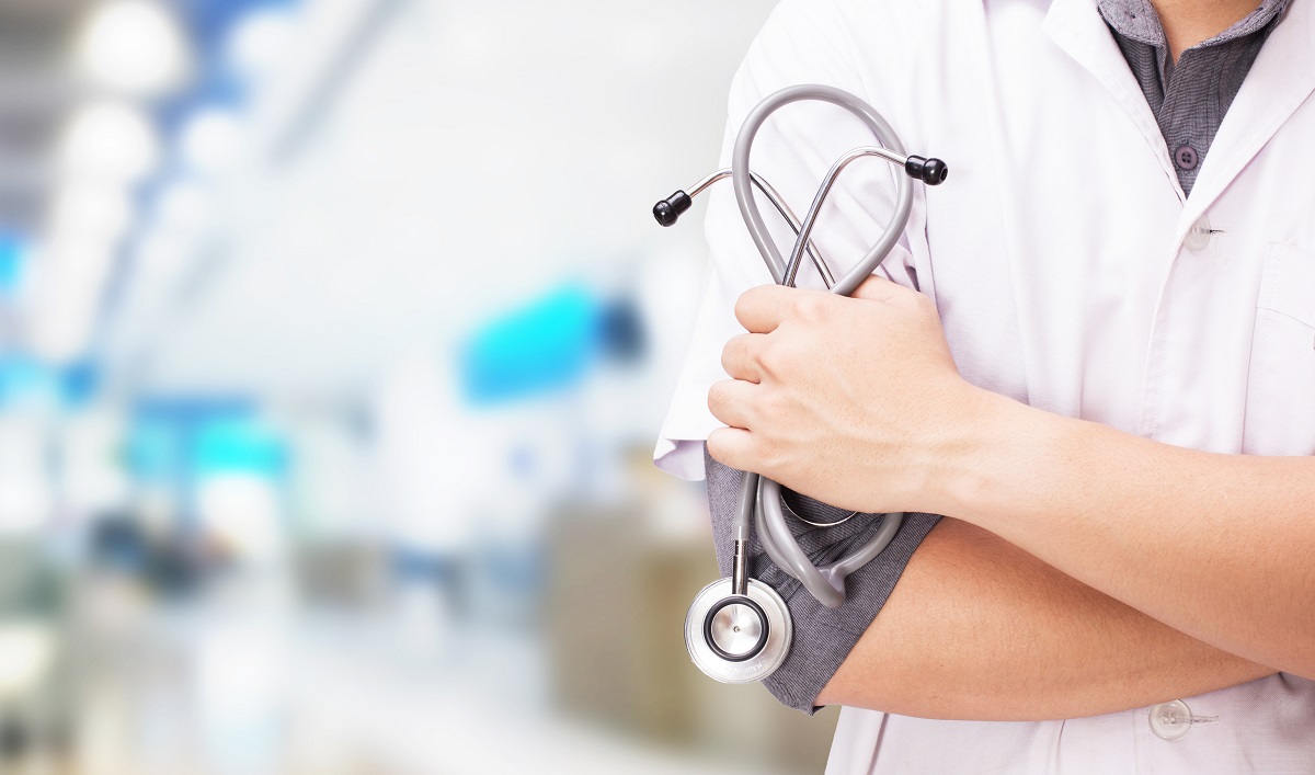 Doctor with a stethoscope in the hands and hospital background